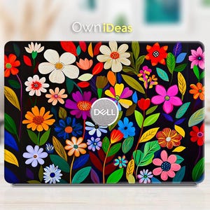May include: A black laptop skin with a colorful floral design. The design features a variety of flowers in shades of red, yellow, blue, green, and purple. The Dell logo is visible in the center of the skin.