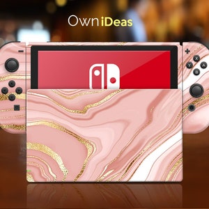 May include: Pink and gold marble design Nintendo Switch console skin with the Nintendo logo on the screen.