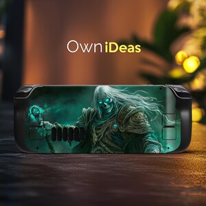 May include: A black gaming console skin with a green and blue design featuring a skeletal figure with glowing eyes. The design is reminiscent of a fantasy character.
