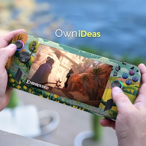 May include: A handheld gaming console with a screen displaying a video game scene. The console has a green and floral design with the text "OwniIdeas" and "Enshrouded". The console is held by a person.