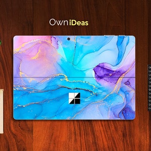 May include: A blue, purple and gold abstract marble design laptop skin with the text "OwnIdeas" at the top.