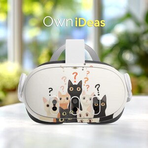 May include: White VR headset with a cat-themed design. The headset features a collection of cartoon cats in various colors, with question marks scattered around. The text "OwniDeas" is displayed in yellow at the top.