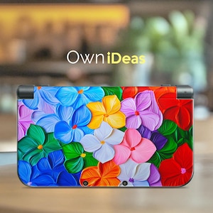 May include: A colorful Nintendo 3DS XL skin featuring a vibrant floral design with blue, red, yellow, green, and purple flowers. The skin is made of high-quality vinyl and is easy to apply and remove.