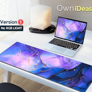 May include: A purple and blue marble-effect desk mat with gold accents. The mat is on a white desk with a laptop and a white lamp. The text "Version 1 No RGB LIGHT" is on the left side of the image.