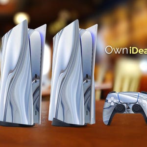 May include: Two white and blue swirl patterned PlayStation 5 consoles with a matching white and blue swirl patterned controller. The consoles are standing upright on a wooden surface. The text "OwnIdeas" is visible in the background.