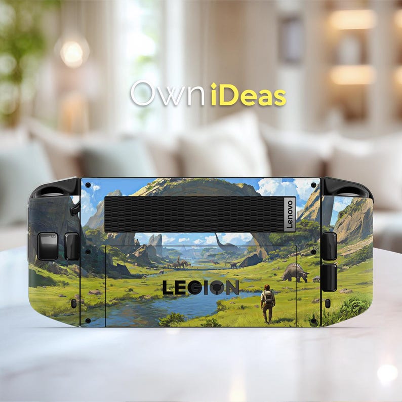 May include: A Lenovo Legion gaming device featuring a landscape design with dinosaurs, mountains, and a river. The device has a black vent and the word "LEGION" is visible. The background is a blurred living room.