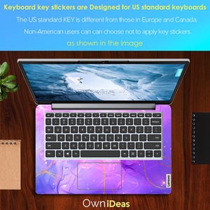 May include: A laptop computer with a purple and gold keyboard sticker. The sticker features a marbled design with gold accents. The laptop is open and the screen is showing a blue sky with clouds. The text "Own iDeas" is printed below the laptop. The text "Lenovo" is printed on the bottom right corner of the laptop.