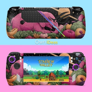 May include: A handheld gaming console with a custom skin featuring a pink creature in a garden scene with fruits and vegetables. The screen displays the game "Stardew Valley". The console has black accents and purple buttons.