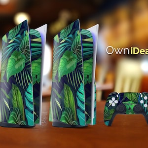 May include: A set of two green and black tropical leaf patterned console covers and a matching controller skin for the Playstation 5 console. The brand name "OwnIdeas" is printed in white on a black background.