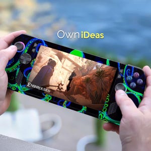 May include: A handheld gaming console with a screen displaying a video game scene. The console has a black and blue design with green accents and the text "OwniIdeas". The game title "Enshrouded" is visible on the screen.
