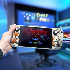 May include: A white handheld gaming console with a black and white cat design on the back. The screen displays a video game called "Vampire Survivors" with a red background and a character in the foreground. The console features a circular button on the left side and a directional pad on the right side.