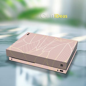 May include: A pink and gold Xbox Series X console skin with a leaf pattern. The skin is designed to fit the console perfectly and is easy to apply and remove. OwnIdeas.