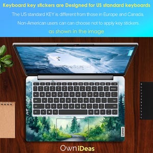 May include: A laptop computer with a green forest scene keyboard sticker. The sticker features a winding road through a forest with trees and a blue sky. The text "Own iDeas" is printed below the keyboard.