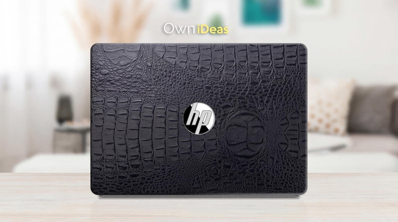 May include: Black laptop skin with a crocodile texture. The HP logo is centered on the skin. The text "OwnIdeas" is in the upper left corner.