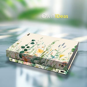 May include: A cream-colored gaming console skin featuring a watercolor floral design with yellow, pink, and green flowers and foliage. The text "OwniIdeas" is visible in the background.