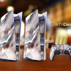 May include: A white gaming console with a marble-like design. The console is in a vertical position and has a controller next to it. The controller is also covered in a marble-like design. The text "OwnIdeas" is visible in the background.