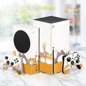May include: White Xbox Series X console with a custom skin featuring a cartoon design of cats with a glass of champagne. The skin is yellow, white, and black. The console is next to a white Xbox Series X controller with a matching skin.