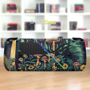 May include: A handheld gaming console with a custom skin featuring a whimsical forest scene. The design includes mushrooms, flowers, and trees in shades of green, yellow, and brown. The text "OwniIdeas" is visible on the device.