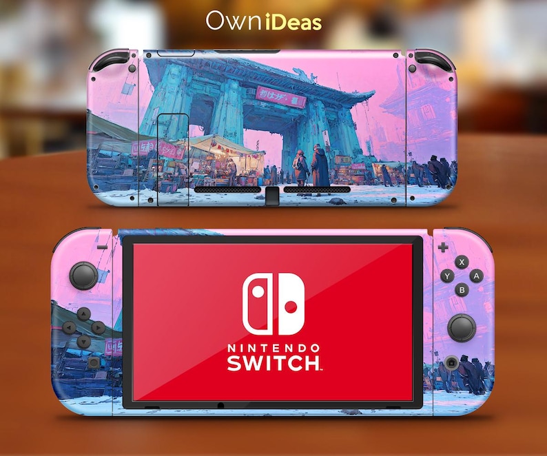 May include: A Nintendo Switch console with a custom skin featuring a pink and blue cityscape design. The skin wraps around the console and Joy-Cons, with the Nintendo Switch logo visible on the screen. The top of the console has the text "OwniDeas".