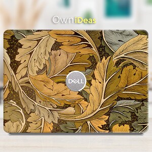 May include: A laptop skin with a vintage floral design featuring brown, yellow, and green leaves. The design is reminiscent of an art nouveau style. The Dell logo is visible on the skin.