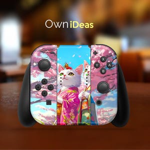 May include: A black Nintendo Switch controller with a custom skin featuring two white cats with pink flowers and a blue sky background. The skin has the text "OwnIdeas" on the top.
