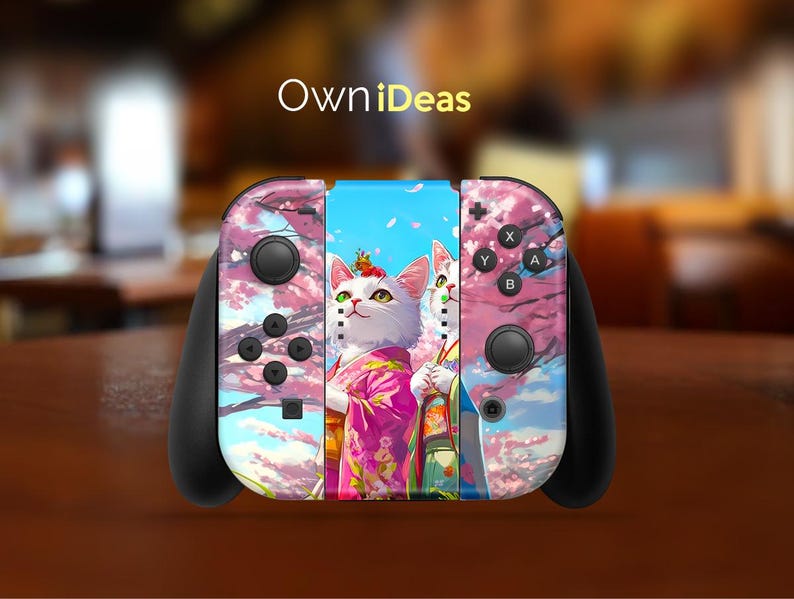 May include: A black Nintendo Switch controller with a custom skin featuring two white cats with pink flowers and a blue sky background. The skin has the text "OwnIdeas" on the top.