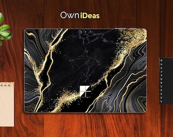 May include: Black and gold marble laptop skin with a gold glitter effect. The skin features a swirling pattern of black and gold marble with gold glitter accents. The skin is designed to fit a laptop with a 13.5-inch screen.