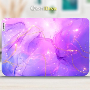 May include: Purple and pink abstract laptop skin with gold lines and glitter. The skin has the word "Lenovo" printed on the left side.