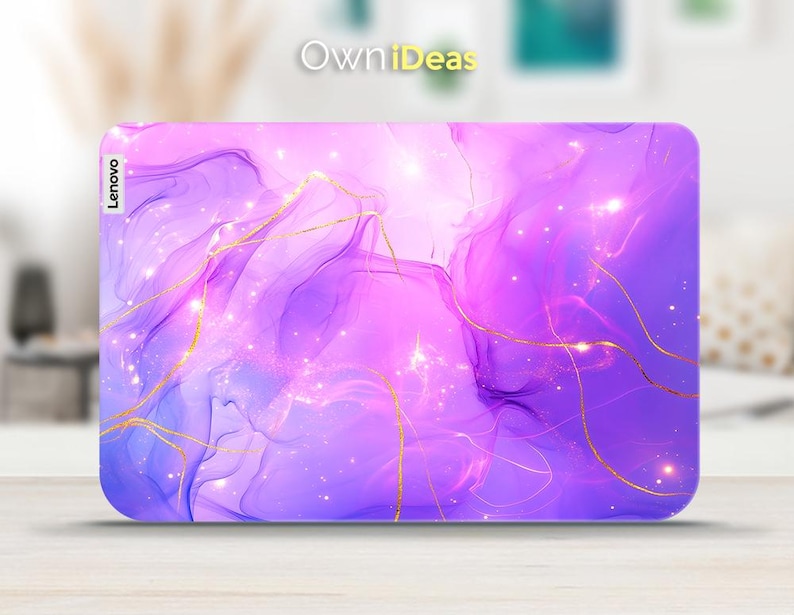 May include: Purple and pink abstract laptop skin with gold lines and glitter. The skin has the word "Lenovo" printed on the left side.
