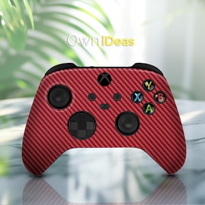 May include: Red carbon fiber Xbox controller with black buttons and a red and black patterned design. The controller has the text "OwnIdeas" printed on it.