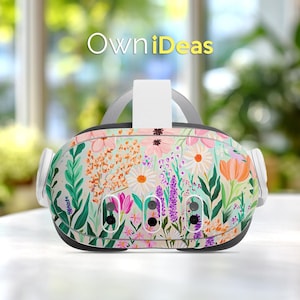 May include: A VR headset with a floral design featuring pink, orange, and purple flowers, along with green leaves, against a light background. The text "OwniDeas" is visible at the top. The headset has white ear pieces and a gray strap.