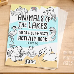 Cover mockup of the printable PDF “Animals of the Lakes” color, cut-and-paste activity book, shown as a stacked booklet on a wooden table with illustrated lake animals on the front cover.