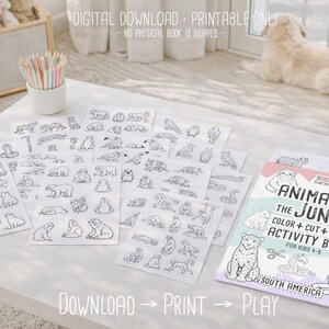 May include: A white table displays a children's activity book titled "Animals of the Jungle" with accompanying coloring pages featuring various jungle animals. The text "Download, Print, Play" is visible. A container of colored pencils is also present.