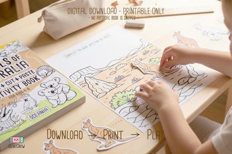 Child placing cut-out kangaroo pieces onto a printed Australia desert scene page, with the “Animals of Australia” activity book visible on a wooden desk, labeled as a digital download printable.