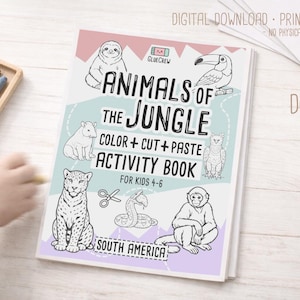 May include: A children's activity book titled "Animals of the Jungle" with illustrations of jungle animals. The book includes the text "Color + Cut + Paste Activity Book for Kids 4-6" and the words "South America". Crayons are in a wooden tray.