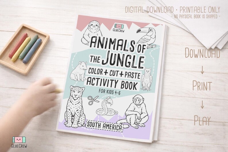 May include: A children's activity book titled "Animals of the Jungle" with illustrations of jungle animals. The book includes the text "Color + Cut + Paste Activity Book for Kids 4-6" and the words "South America". Crayons are in a wooden tray.