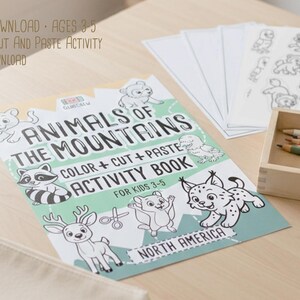May include: A children's activity book titled "Animals of the Mountains" with illustrations of various animals. The book includes the text "Color + Cut + Paste Activity Book" and is designed for kids ages 3-5. Pencils and coloring pages are also visible.