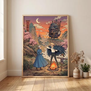 May include: A framed art print featuring a scene from the animated film "Howl's Moving Castle." The artwork depicts characters in a vibrant landscape with a castle, a bonfire, and Japanese text. The color palette includes warm oranges, pinks, and blues.