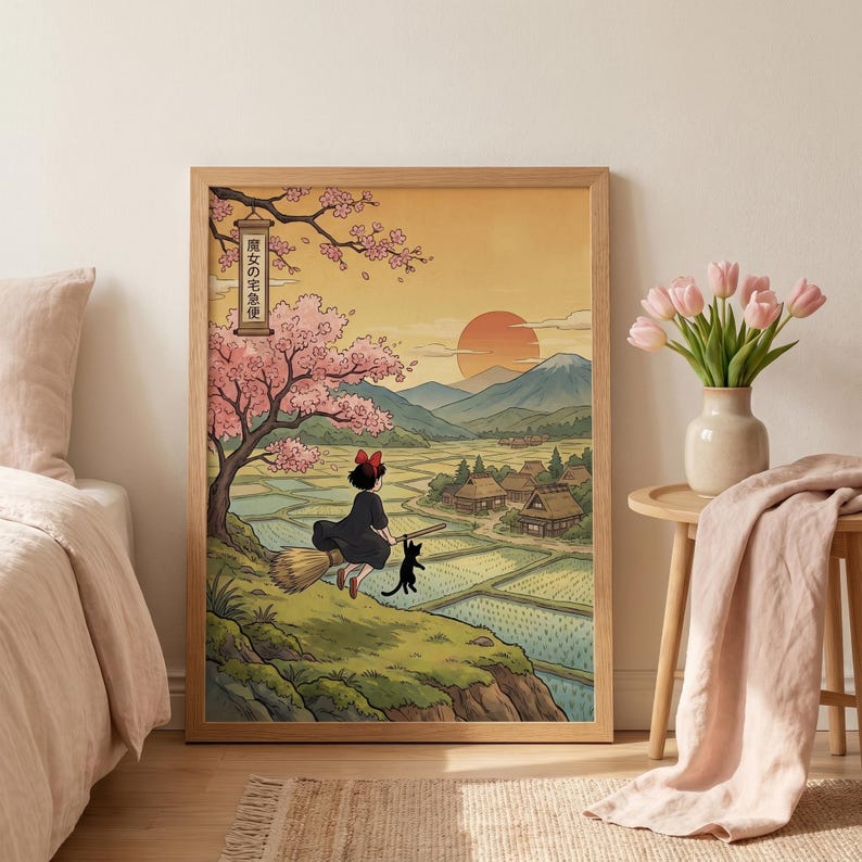 May include: A framed art print featuring a young witch flying on a broom with a black cat, set against a Japanese landscape. The artwork includes cherry blossoms, rice fields, and a sunset. The text in the image reads "魔女の宅急便".