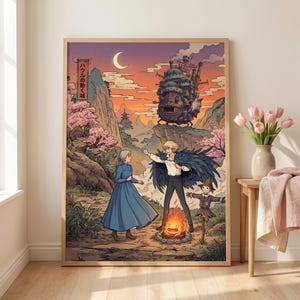 May include: A framed art print featuring a scene from "Howl's Moving Castle." The artwork depicts characters in a vibrant landscape with a castle, mountains, and a bonfire. Japanese text is visible in the upper left corner. The color palette includes shades of blue, orange, and pink.