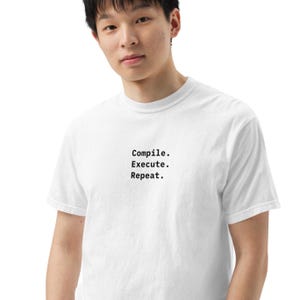 May include: A white ceramic mug with a black handle and the text "But First, Coffee" in a handwritten style. The mug is on a white surface. The mug is 10 cm tall.