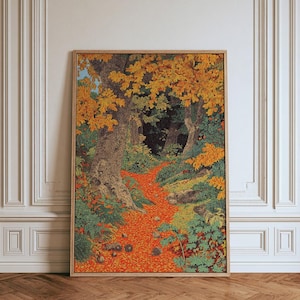 May include: A rectangular framed wall art piece featuring a detailed illustration of a forest path covered in vibrant orange fallen leaves. The scene includes textured tree trunks, dense green foliage, and a dark, shadowed background area.