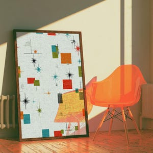 May include: A rectangular framed wall art piece featuring a white background with a repeating pattern of orange, red, blue, and green squares interspersed with black starburst shapes and thin lines, displayed in a dark wooden frame.