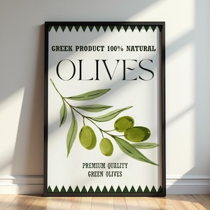 May include: A framed poster with a black border displays the word "OLIVES" in large, bold letters. The poster includes a watercolour illustration of a green olive branch with olives. Text at the top reads "GREEK PRODUCT 100% NATURAL".