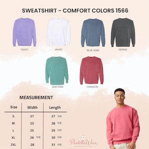 May include: Image of crewneck sweatshirts in violet, white, blue jean, pepper, seafoam, and crimson. A size chart shows measurements in inches, with the smallest size having a width of 21 inches and a length of 27.5 inches. A person models a crimson sweatshirt.