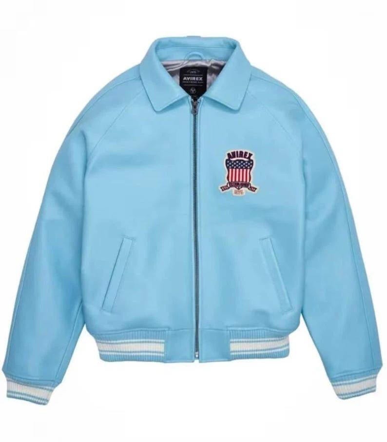 May include: Light blue leather jacket with a zip-up front, collar, and a ribbed hem and cuffs with white stripes. Features a patch on the chest with the text "AVIREX" and a patriotic design.