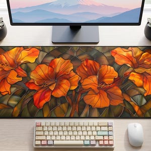 May include: A rectangular desk mat featuring a vibrant stained glass pattern of four large orange hibiscus flowers with dark green foliage. The design uses bold black outlines to separate the orange, yellow, and deep green color segments.