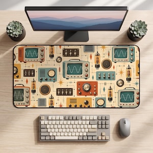 May include: A rectangular desk mat featuring a repeating pattern of vintage electronics, including cathode ray tube televisions with sine wave screens, vacuum tubes, analogue dials, and toggle switches in shades of orange, teal, and cream.