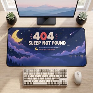 May include: A rectangular desk mat featuring a dark blue night sky with a smiling yellow crescent moon, purple clouds, and the text 404 SLEEP NOT FOUND, MOON SERVICE UNAVAILABLE, TRY AGAIN TOMORROW. The design includes stars, code brackets, and a landscape.