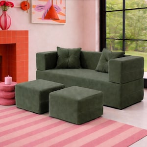 May include: A dark olive green sofa with a low back and wide armrests, accompanied by two matching square ottomans. The sofa features two tufted square throw pillows in the same olive green fabric, creating a cohesive seating set for a living space.